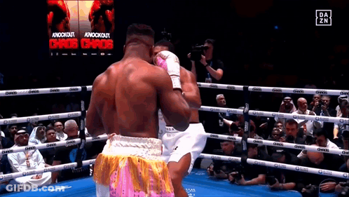 Boxers Fighting In Ring With Chaos Sign GIF