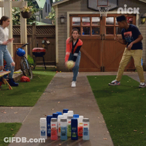 Boy And Girl Bowling In Front Of Nick Basketball Hoop GIF