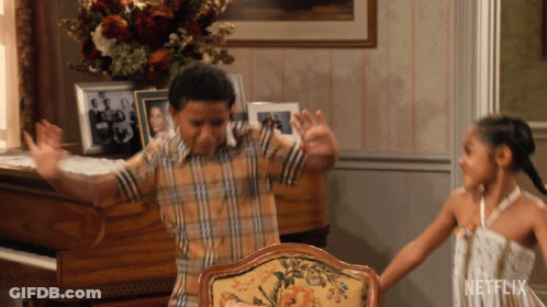 Boy And Girl Dancing In Living Room With Netflix Logo GIF