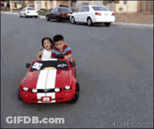 Boy And Girl Driving Red Mustang Toy Car GIF