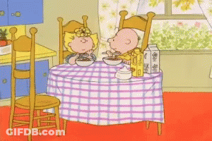 Boy And Girl Eating Cereal At Table GIF