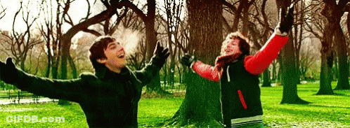 Boy And Girl Jumping In Park GIF