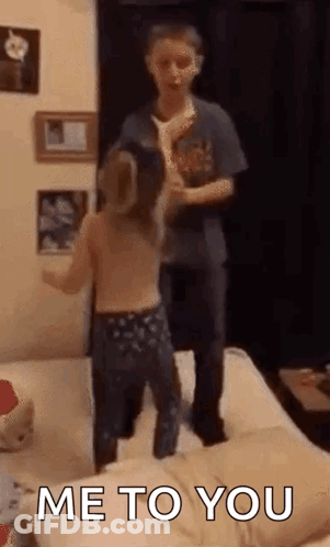 Boy And Girl Jumping On Bed GIF