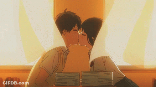 Boy And Girl Kissing In Front Of Books GIF