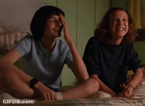 Boy And Girl Laughing On Bed GIF