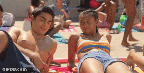 Boy And Girl Laying On Beach GIF