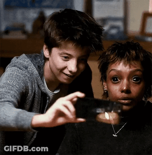 Boy And Girl Looking At Candle In Glass GIF