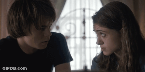 Boy And Girl Looking At Each Other By Window GIF