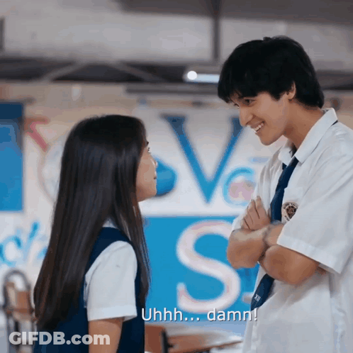 Boy And Girl Looking At Love Sign GIF