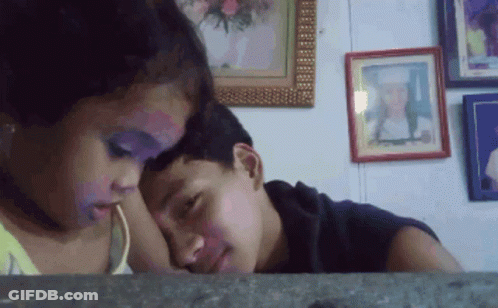 Boy And Girl Looking At Wall With Framed Pictures GIF