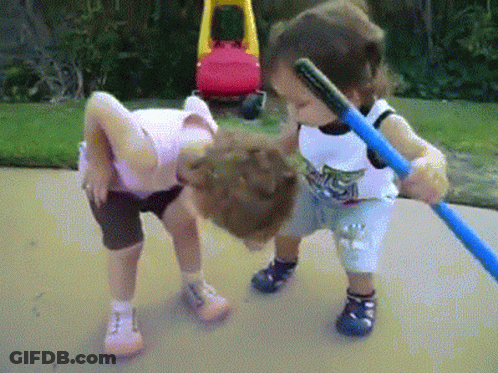 Boy And Girl Playing With Hula Hoop On Sidewalk GIF
