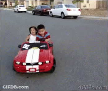 Boy And Girl Riding Red Toy Car GIF