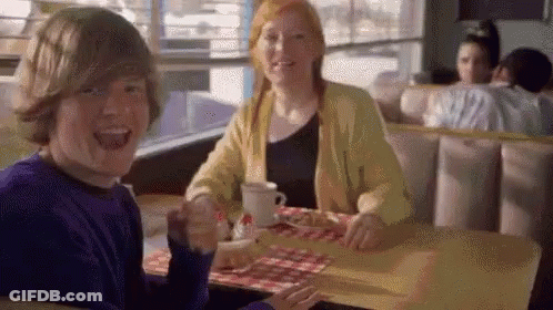 Boy And Girl Sitting At Diner Table GIF
