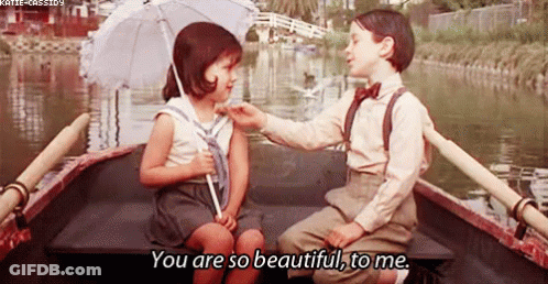 Boy And Girl Sitting In Boat On Water GIF