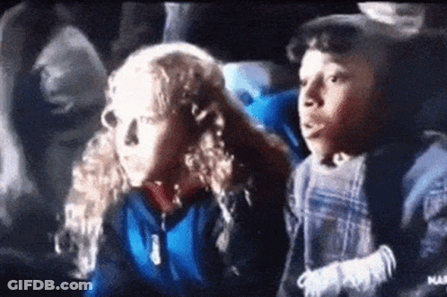 Boy And Girl Sitting In Theater Watching Movie GIF