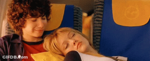 Boy And Girl Sitting On Plane GIF