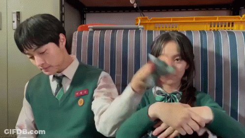 Boy And Girl Sitting On Striped Couch Holding Arm GIF