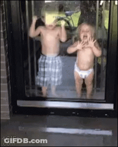Boy And Girl Standing In Front Of Window GIF