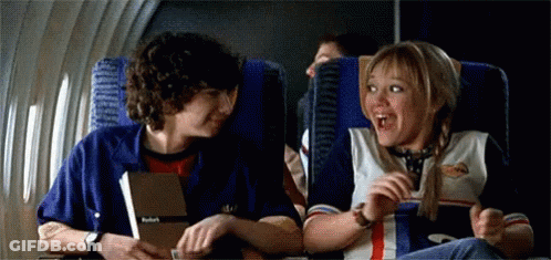 Boy And Girl Talking On Airplane GIF