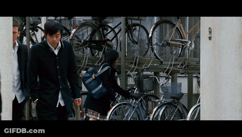 Boy And Girl Walking Past Bikes GIF