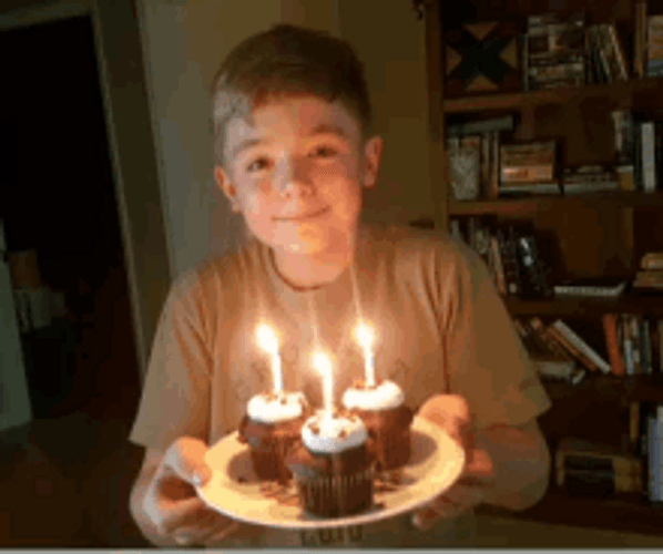 Boy Blowing Birthday Candles On Cupcakes Transition GIF