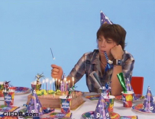Boy Blows Out Birthday Cake Candles Wearing Happy Birthday Hat GIF