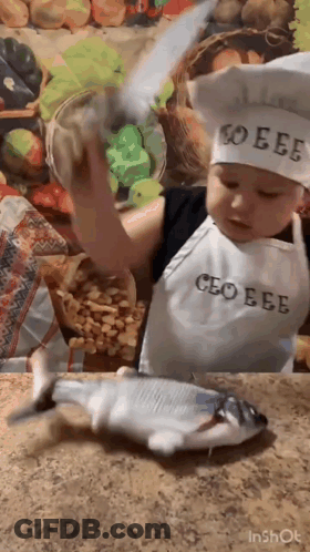 Boy Chef Holding Knife Over Fish GIF
