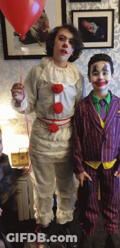 Boy Dressed As Clown Holding Red Balloon GIF
