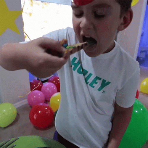 Boy Eating Cake On Birthday Party GIF