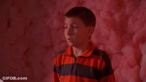 Boy Eating Pink Cotton Candy In Front Of Pink Wall GIF