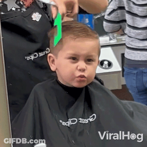 Boy Getting Haircut From Barber In Classic Clips Apron GIF