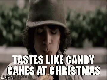 Boy In Baseball Cap Eating Candy Cane GIF