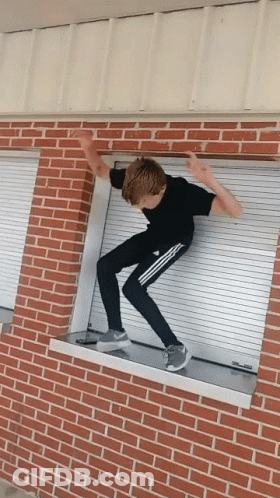 Boy In Black Shirt Jumping Over Window GIF