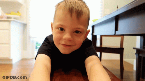 Boy In Black Shirt Lying Smiling GIF