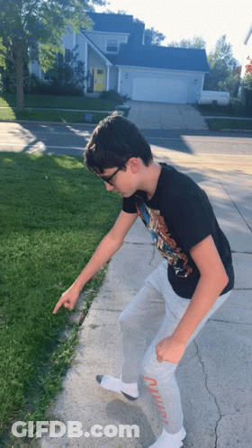 Boy In Black T-Shirt And Grey Sweatpants Pointing GIF