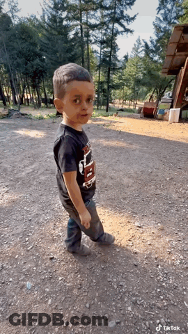 Boy In Black Thunder Shirt Standing In Dirt GIF