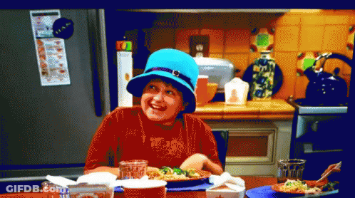 Boy In Blue Hat Sitting At Table With Food GIF