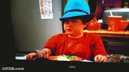 Boy In Blue Hat Sitting At Table With Vizio TV GIF