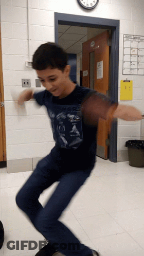 Boy In Blue Shirt Jumping Before Clock GIF