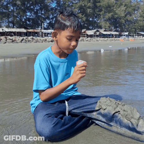 Boy In Blue Shirt Saying Converse Sits In Water GIF