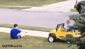 Boy In Blue Shirt Sitting Next To Yellow Toy Car GIF