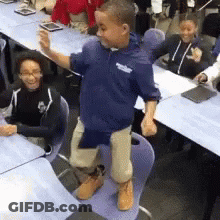Boy In Blue Shirt Standing On Chair GIF