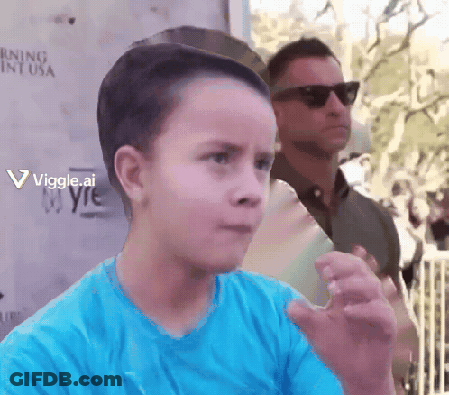 Boy In Blue Standing Before Warning Sign GIF