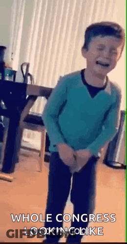 Boy In Blue Sweater Standing In Living Room GIF