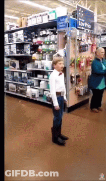 Boy In Bow Tie By Low Price Sign GIF