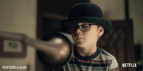 Boy In Bowler Hat And Glasses With Netflix Logo GIF