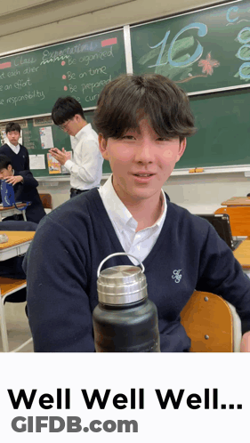 Boy In Classroom With Number 16 GIF
