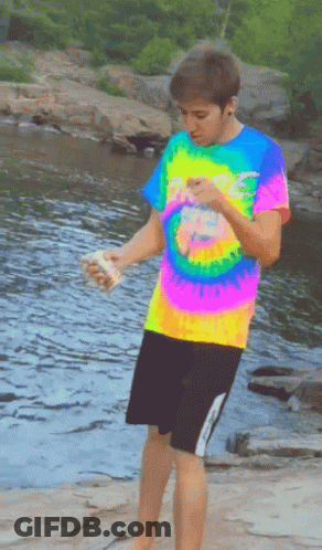 Boy In Colorful Tie-Dye Shirt By River GIF