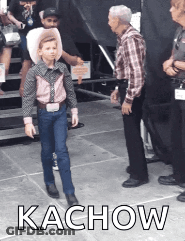 Boy In Cowboy Outfit Next To Man In Plaid Shirt GIF