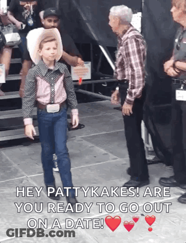 Boy In Cowboy Outfit Talking To Man In Plaid Shirt GIF
